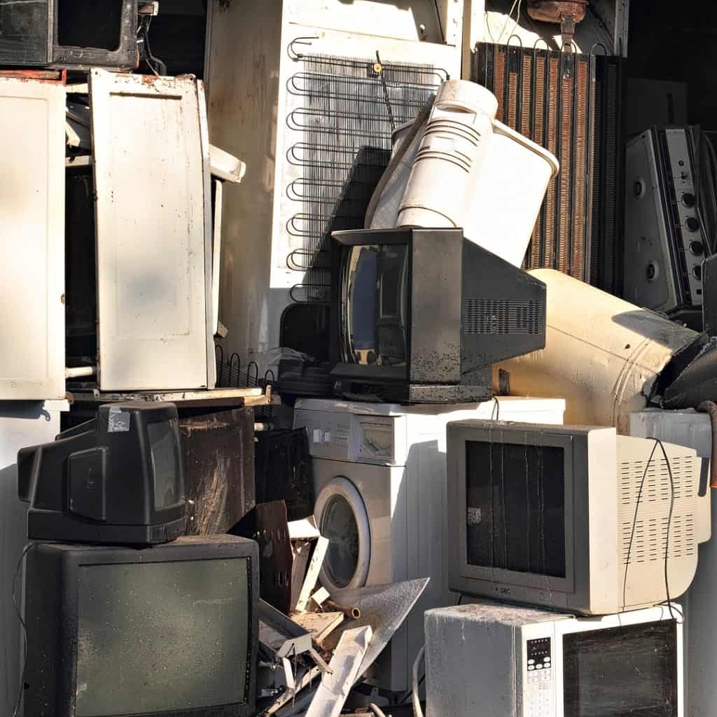Old tech and home appliances in a landfill.
