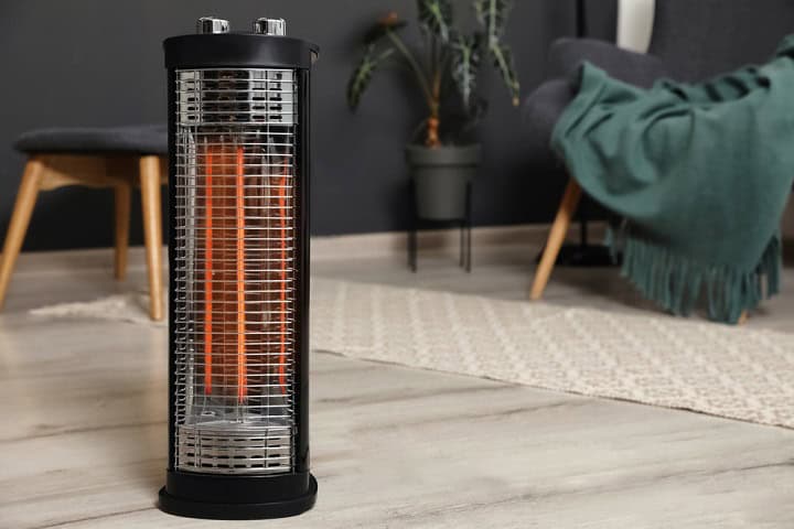 Modern electric halogen heater on floor in room interior