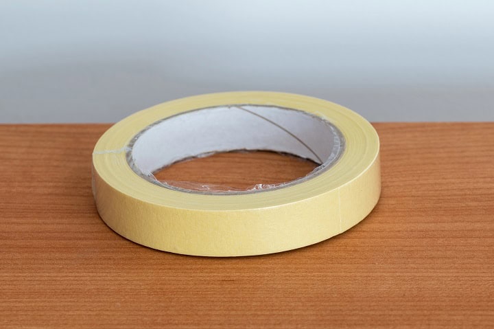 Roll of masking tape on a wood table