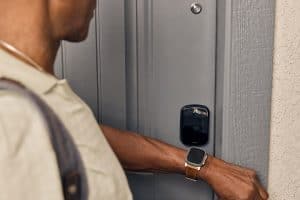 Person unlocking their SmartRent door lock with an Apple watch