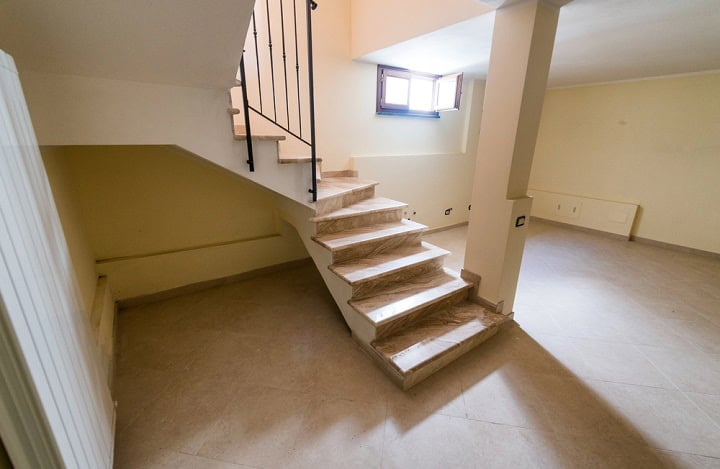 Alcove under basement stairs.