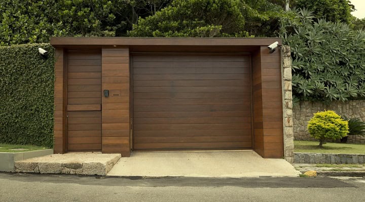 Motion detecting security cameras facing a garage door.