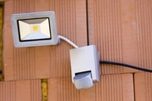 Motion detector and light mounted on outside of home.